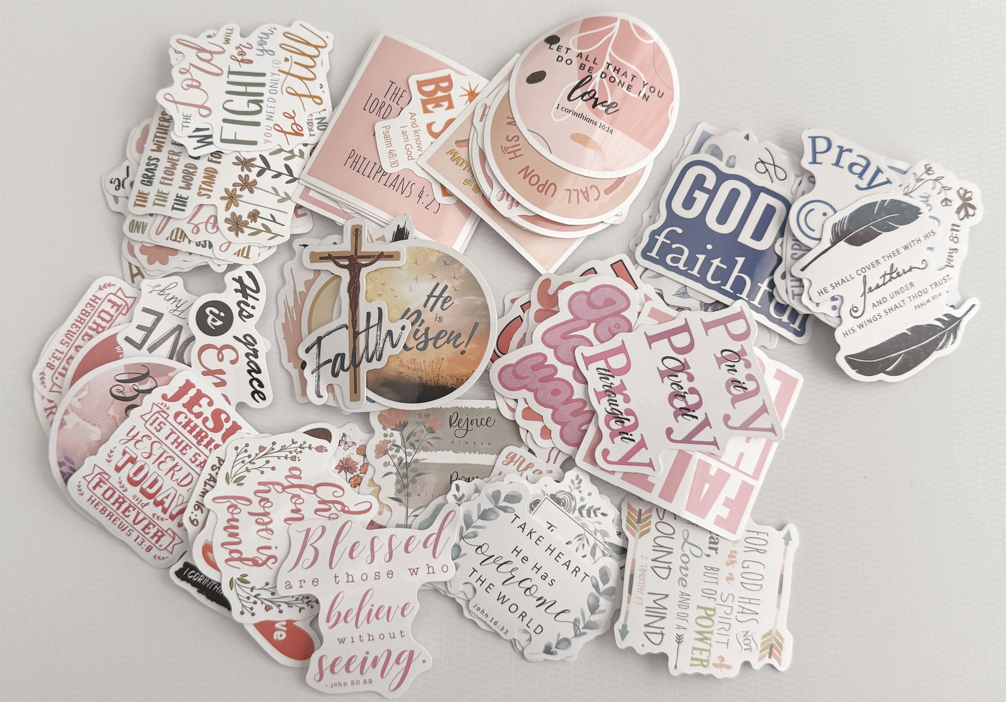 Collection of biblical and inspirational stickers on a light gray background